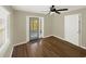 Bright living room with wood floors, ceiling fan, and access to a screened-in porch at 2317 10Th St, St Cloud, FL 34769