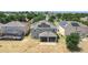 Rear aerial view of home showcasing solar panels, screened in patio and pool at 238 Granada Ave, Davenport, FL 33837