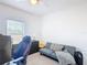 Neutral color bedroom with carpet, fan, window with blinds, and a sofa at 238 Granada Ave, Davenport, FL 33837