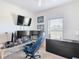 This bedroom has carpet floors, ceiling fan, window overlooking the yard, and a flat screen tv on the wall at 238 Granada Ave, Davenport, FL 33837
