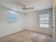 This carpeted bedroom with windows features a ceiling fan and good natural light at 238 Granada Ave, Davenport, FL 33837