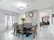 Elegant dining room with a stone accent wall and a dining set for six guests at 238 Granada Ave, Davenport, FL 33837