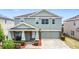 Charming two-story home with a well-manicured front yard and a two-car garage at 238 Granada Ave, Davenport, FL 33837