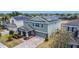 Aerial view of a two-story home with solar panels and a well-maintained lawn at 238 Granada Ave, Davenport, FL 33837