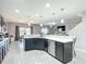 Open-concept kitchen features stainless appliances, center island, and eat-in dining area at 238 Granada Ave, Davenport, FL 33837