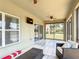 Comfortable screened patio featuring tile floors, ceiling fan and access to the backyard at 238 Granada Ave, Davenport, FL 33837