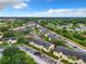 Aerial view of an apartment complex with tennis courts, parking, and lush green landscaping in a suburban setting at 2408 Barley Club Ct # 2, Orlando, FL 32837