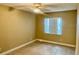 A bright bedroom with neutral walls, tile floors and a ceiling fan at 2408 Barley Club Ct # 2, Orlando, FL 32837