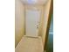 A view of the entryway with the front door, tiled flooring, and neutral walls provide a clean and welcoming entrance at 2408 Barley Club Ct # 2, Orlando, FL 32837