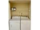 A laundry room with a stacked washer and dryer unit, maximizing space and convenience for laundry tasks at 2408 Barley Club Ct # 2, Orlando, FL 32837