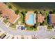 Aerial view of the neighborhood pool with parking, chaise lounges, and bathrooms at 2462 Hassonite St, Kissimmee, FL 34744