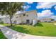 Well-maintained backyard featuring a lush green lawn, a charming patio area, and white fencing at 2462 Hassonite St, Kissimmee, FL 34744