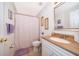 Bathroom featuring a shower with a floral curtain, toilet, and vanity at 2462 Hassonite St, Kissimmee, FL 34744