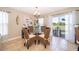 Cozy dining room with glass table, rattan chairs, and natural light pouring in from sliding glass doors at 2462 Hassonite St, Kissimmee, FL 34744