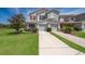 Charming townhome featuring a well-manicured lawn and a two-car garage at 2462 Hassonite St, Kissimmee, FL 34744