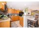 Efficient kitchen featuring wood cabinets, breakfast bar with barstool seating and recessed lighting at 2462 Hassonite St, Kissimmee, FL 34744