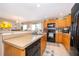 Modern kitchen with stainless steel sink, breakfast bar, and dark wood cabinets that offer ample storage at 2462 Hassonite St, Kissimmee, FL 34744