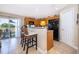 Well-equipped kitchen with wood cabinets, breakfast bar, and sliding glass door to outdoor patio at 2462 Hassonite St, Kissimmee, FL 34744