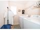 Laundry room with a washer, dryer, and rack at 2462 Hassonite St, Kissimmee, FL 34744