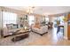 Bright living room featuring stylish furniture, tile floors, and sliding glass doors to bring the outside in at 2462 Hassonite St, Kissimmee, FL 34744