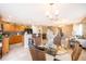 Open-concept kitchen and living space with tile flooring, breakfast bar seating, and a bright, airy feel at 2462 Hassonite St, Kissimmee, FL 34744