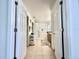 Hallway view of the bright bathroom featuring a vanity, bathtub and storage at 2511 Balmoral Dr, Kissimmee, FL 34744