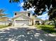 Charming two-story home featuring an attached two-car garage, neat landscaping, and a welcoming driveway at 2511 Balmoral Dr, Kissimmee, FL 34744