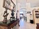 Elegant hallway with tile flooring, arched doorway, and decorative statues on a console table at 2511 Balmoral Dr, Kissimmee, FL 34744