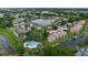 Aerial view of community with waterways, pool, and lush landscaping at 2662 Emerald Lake Ct, Kissimmee, FL 34744