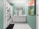 Stylish bathroom with dual sinks, a shower with a decorative curtain, and bright lighting at 2662 Emerald Lake Ct, Kissimmee, FL 34744