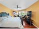 Comfortable bedroom boasting hard wood floors, a black four post bed and lots of natural light at 2662 Emerald Lake Ct, Kissimmee, FL 34744
