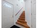 Inviting entryway featuring wood stairs and a large white door with glass inserts at 2662 Emerald Lake Ct, Kissimmee, FL 34744