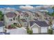 A multi-Gathering home boasts charming curb appeal with colorful landscaping and private garages at 2662 Emerald Lake Ct, Kissimmee, FL 34744
