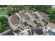 Exterior view of townhomes showing decorative landscaping and private entryways at 2662 Emerald Lake Ct, Kissimmee, FL 34744