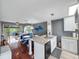 Open kitchen featuring an island with countertop seating, stainless steel appliances, and views of the living area at 2662 Emerald Lake Ct, Kissimmee, FL 34744