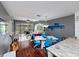 Bright living room with hardwood floors, comfortable seating, and access to a screened patio, creating a welcoming space at 2662 Emerald Lake Ct, Kissimmee, FL 34744