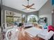Living room with sleek furniture, hardwood floors, and sliding glass doors leading to outdoor patio at 2662 Emerald Lake Ct, Kissimmee, FL 34744
