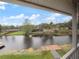 The view from the screened-in patio is of the lake, docks, and lush landscaping at 2662 Emerald Lake Ct, Kissimmee, FL 34744