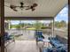 The covered patio features ceiling fans and comfortable seating for relaxing and enjoying the view at 2662 Emerald Lake Ct, Kissimmee, FL 34744
