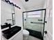 Modern bathroom with black fixtures, glass enclosed shower and stylish vanity at 2663 Oneida Loop, Kissimmee, FL 34747