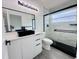 Modern bathroom features black hardware, floating vanity, and a glass shower enclosure at 2663 Oneida Loop, Kissimmee, FL 34747