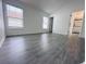 Bright bedroom boasts ample natural light from two windows and modern gray laminate flooring at 2663 Oneida Loop, Kissimmee, FL 34747