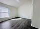 Bright bedroom with wood floors and a window bringing in natural light at 2663 Oneida Loop, Kissimmee, FL 34747