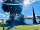 Charming single-story home with well-manicured lawn, palm trees, and attached two-car garage at 2663 Oneida Loop, Kissimmee, FL 34747