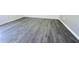 Close up of gray wood-look flooring and white trim at 2663 Oneida Loop, Kissimmee, FL 34747