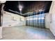 Spacious garage with overhead lighting, sleek black ceiling, and light gray laminate flooring at 2663 Oneida Loop, Kissimmee, FL 34747