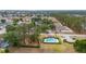 Aerial view of the community with a pool, playground, and lush greenery; ideal for Gathering-friendly living at 301 Wingdale Way, Davenport, FL 33897