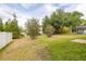 Spacious backyard with lush green grass and shade trees at 301 Wingdale Way, Davenport, FL 33897