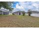 Spacious backyard featuring a covered lanai and mature trees, perfect for outdoor entertaining and relaxation at 301 Wingdale Way, Davenport, FL 33897