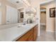 Well-lit bathroom featuring a vanity, white sink, and large mirror at 301 Wingdale Way, Davenport, FL 33897